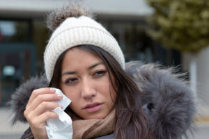 A women dealing with dry eye due to the cold weather outside