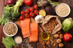 A picture of various foods like salmon, almonds, broccoli and others 