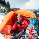 Man camping in the snow