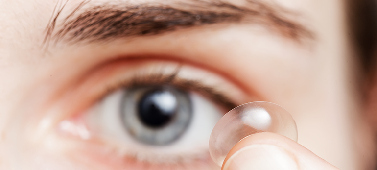 Woman applying Contact Lenses