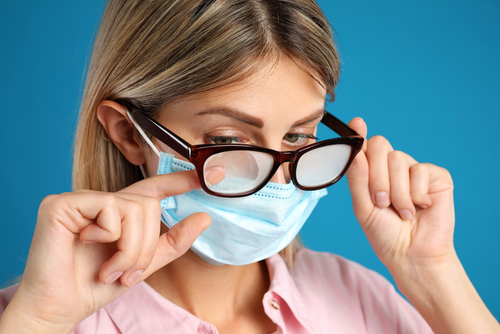 Woman wearing foggy eyeglasses before LASIK